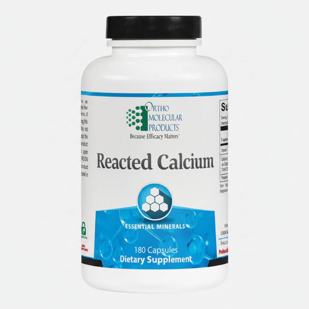 Supplement bottle labeled 'Reacted Calcium' by Ortho Molecular Products on a white background