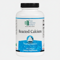 Supplement bottle labeled 'Reacted Calcium' by Ortho Molecular Products on a white background