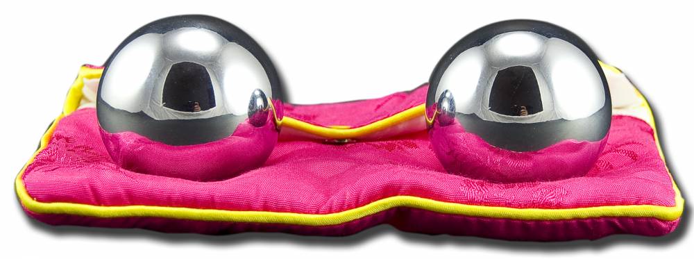 Two polished Acuspheres reflex balls with a pink satin pouch