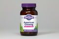 Vitamin supplement bottle labeled 'American Ginseng' with a purple cap and white label.