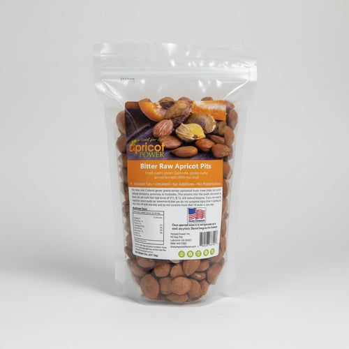 Bag of bitter raw apricot pits with a visible label on a white background