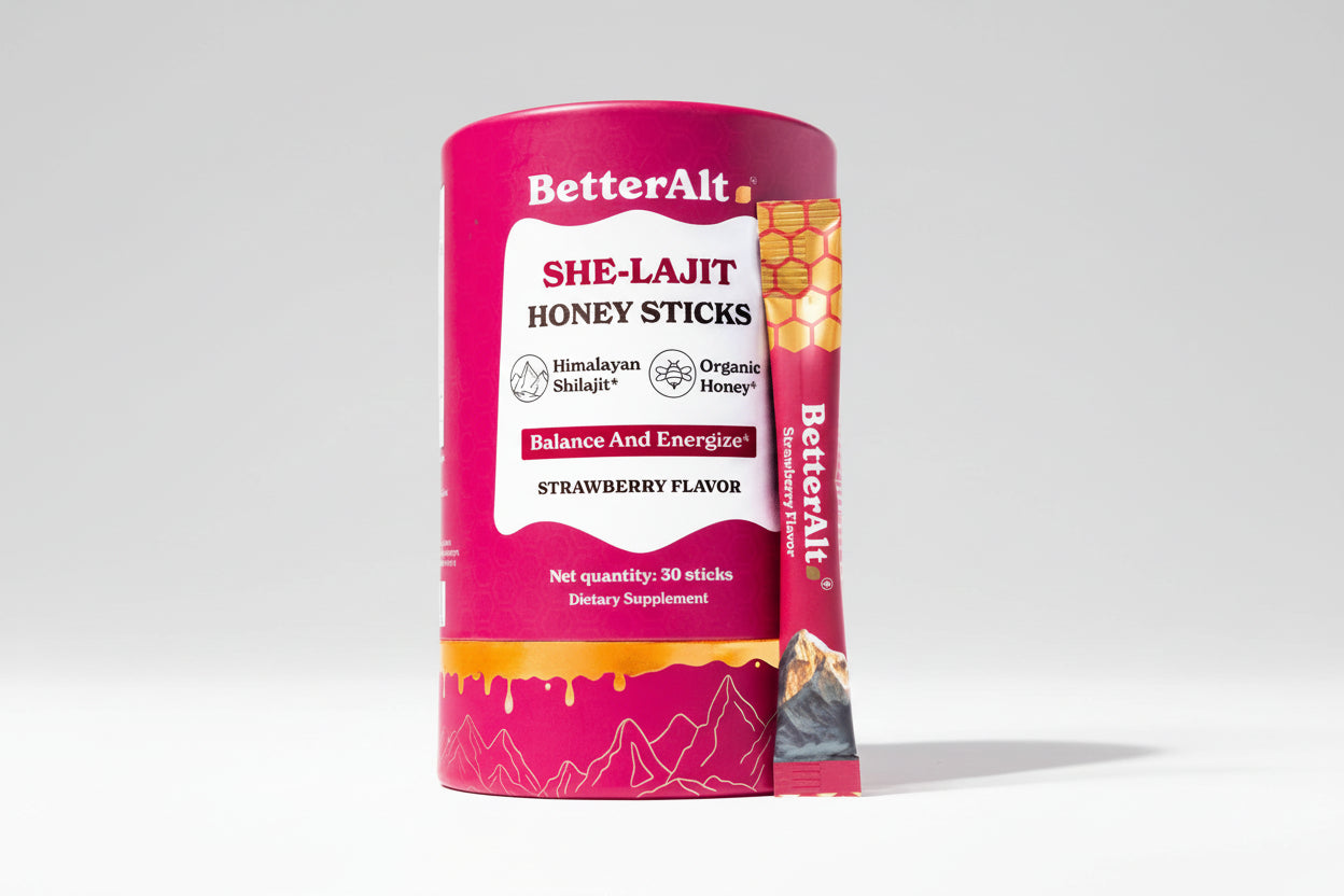 Pink container of BetterAlt SHE-LAJIT Honey Sticks with strawberry flavor on a white background