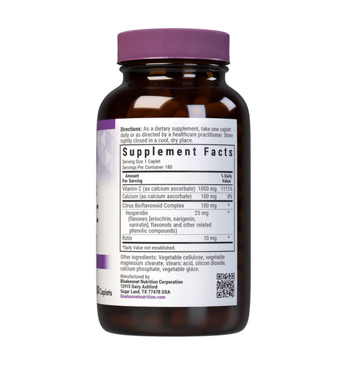 Vitamin supplement bottle with purple cap and label on a white background