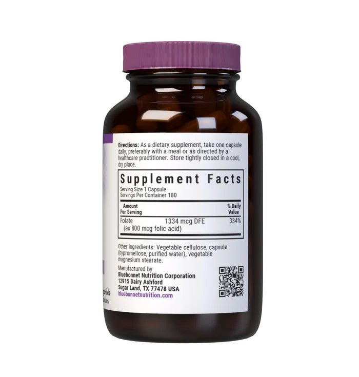 Vitamins bottle with purple cap and label on a white background