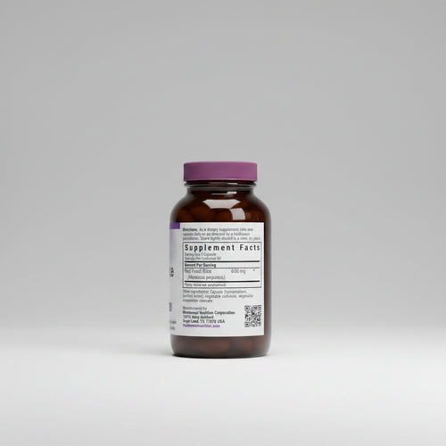 Brown supplement bottle with purple cap and label on a white background