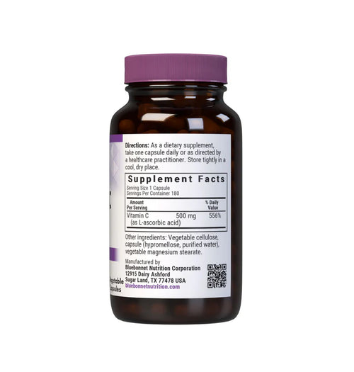 Brown supplement bottle with purple cap on a white background