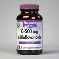 Vitamin C supplement bottle with purple cap and label on a white background