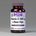 Vitamin C-500 mg & Rose Hips supplement bottle with purple cap on a white background