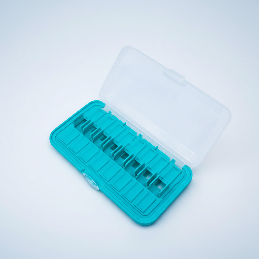 Turquoise ice cube tray with clear lid on a white background
