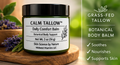 Calm Tallow Daily Comfort Balm jar on a wooden surface with greenery in the background