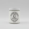 Jar of Midwest Vitamins Tallow Cream on a wooden surface with a white background