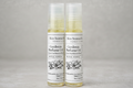 Bottles of Skin Science by Mwylte Gardenia Perfume Oil with a gardenia flower on a light background