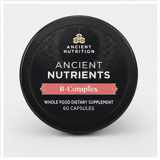 A round black supplement container lid for Ancient Nutrition B-Complex dietary supplement, featuring white text and a coral pink banner on a light gray background.