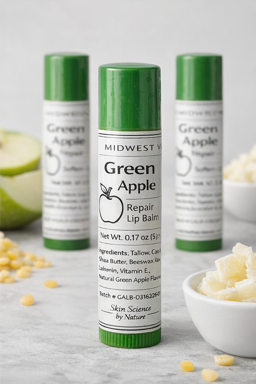 Green Apple lip balm with ingredients on a gray surface