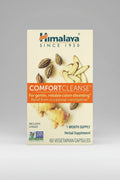 Himalaya Comfort Cleanse supplement packaging with ginger and other herbs on a beige background.