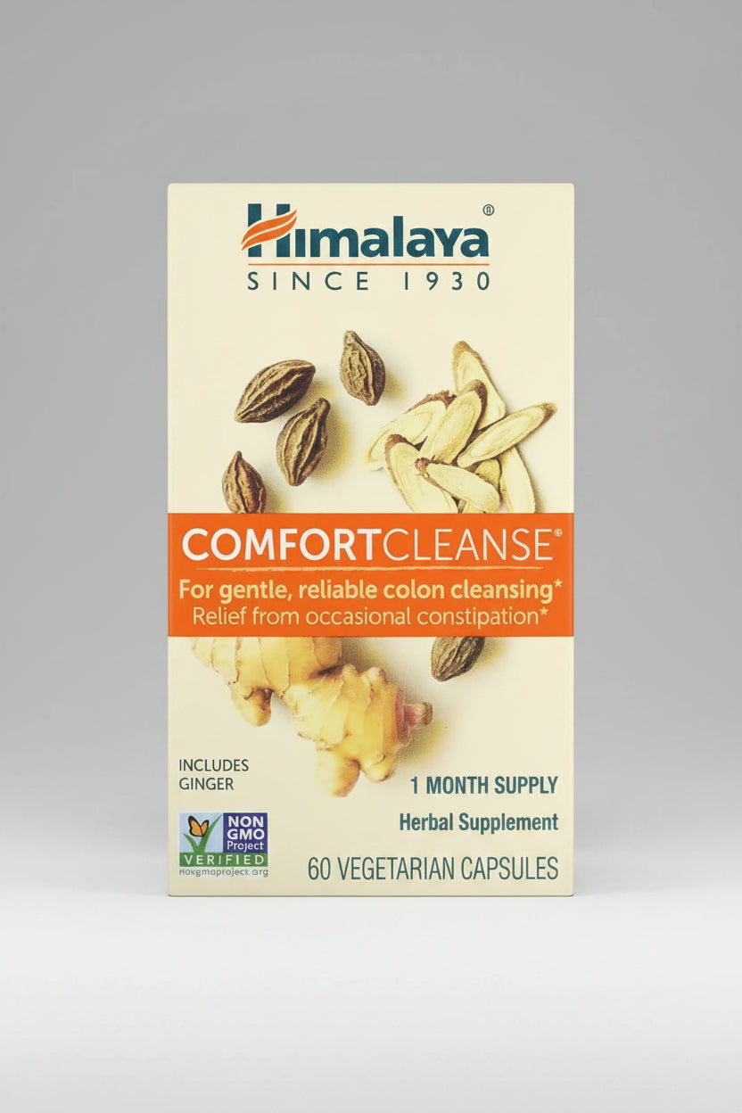 Himalaya Comfort Cleanse supplement packaging with ginger and other herbs on a beige background.