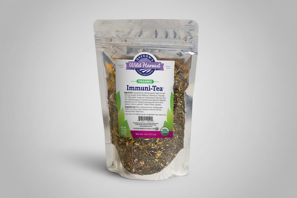 Bag of Oregon Wild Harvest Immuni-Tea with a wooden bowl of tea leaves on a white surface.