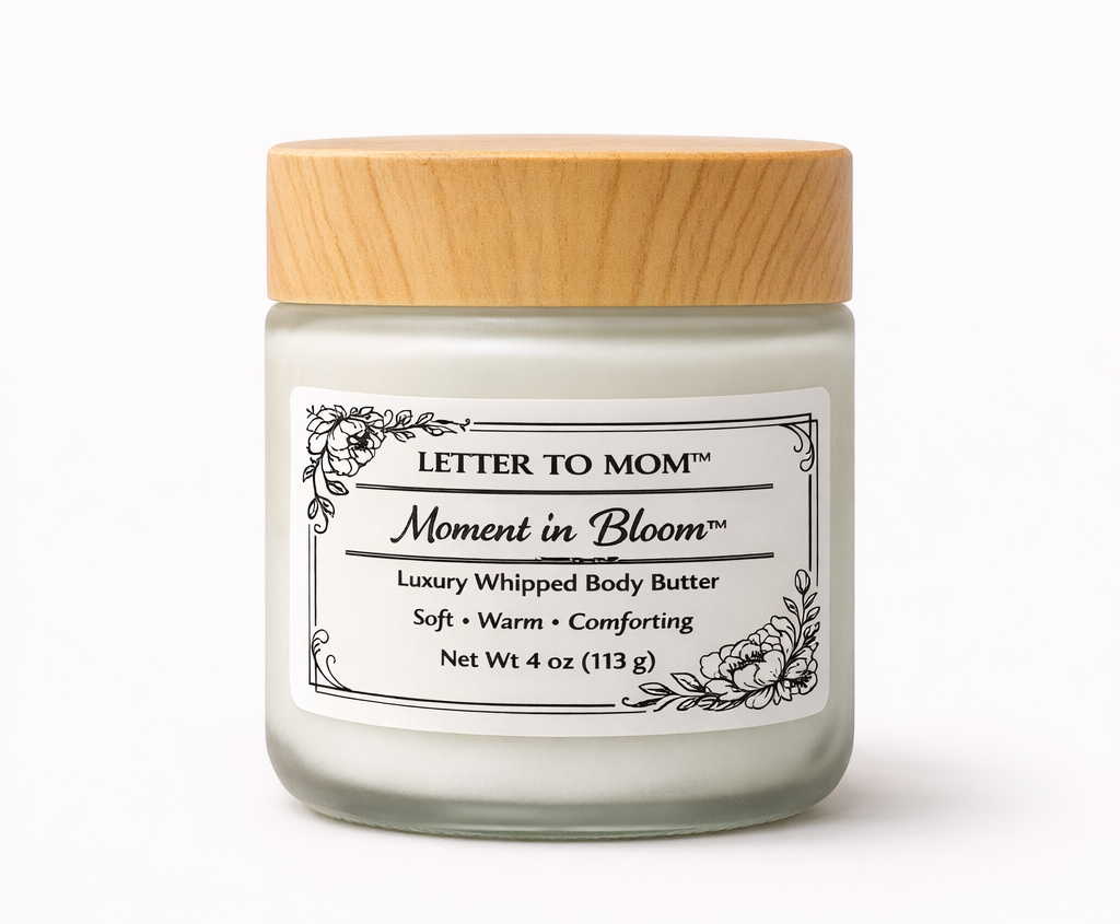 Jar of 'Moment in Bloom' body butter with a wooden lid on a white background