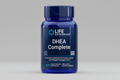 Blue supplement bottle labeled 'DHEA Complete' by Life Extension on a white background