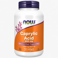 A white bottle of NOW Caprylic Acid 600 mg dietary supplement with a dark purple cap and an orange label, shown on a light gray background.