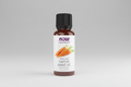 Bottle of NOW essential oils carrot seed oil on a white background