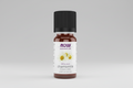 Bottle of Now Essential Oils chamomile oil on a white background