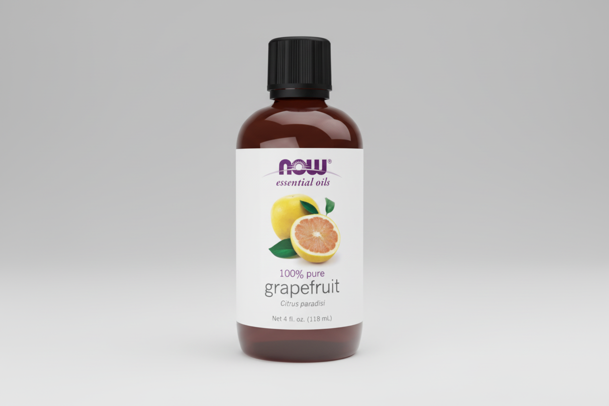 Bottle of NOW essential oils with grapefruit flavor on a white background