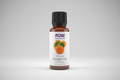 Bottle of Now Essential Oils tangerine oil on a white background