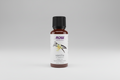 Bottle of vanilla extract in jojoba oil with NOW Solutions label on a white background