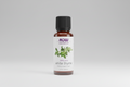 Bottle of NOW Essential Oils White Thyme oil on a white background