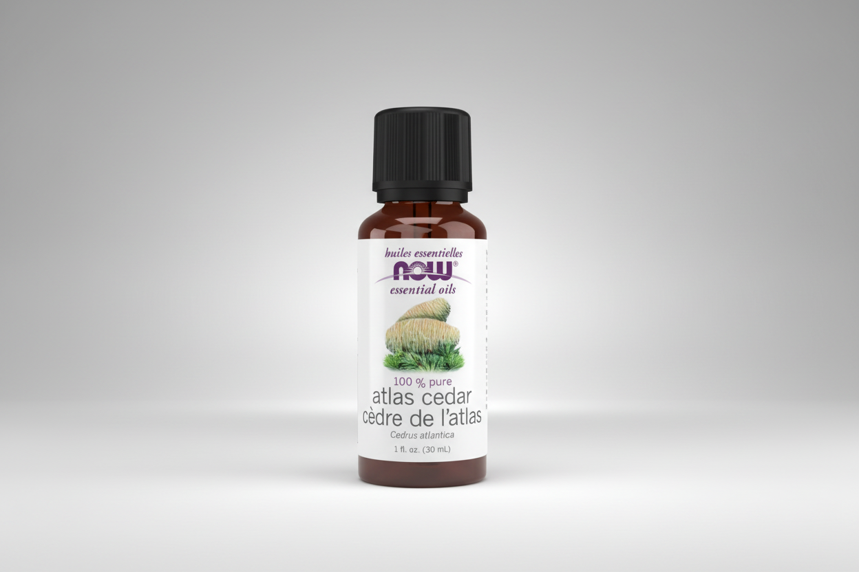 Bottle of atlas cedar essential oil with NOW brand on a white background