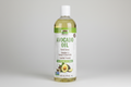 Bottle of avocado oil with a white label on a white background