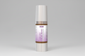 Skincare serum bottle with a white cap and purple label on a white background