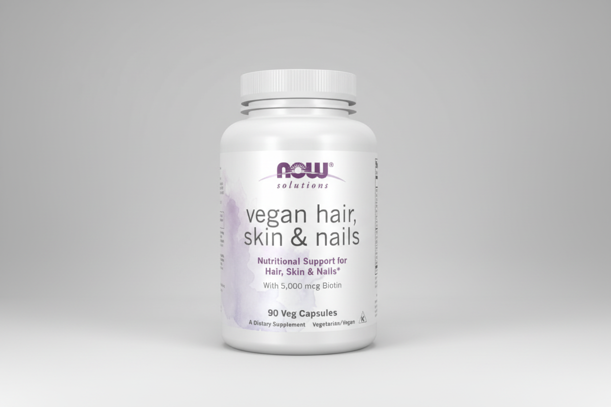 Supplement bottle labeled 'vegan hair, skin & nails' with NOW Solutions branding on a white background.