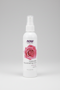 Rosewater rejuvenating mist bottle with a pink rose on a white background
