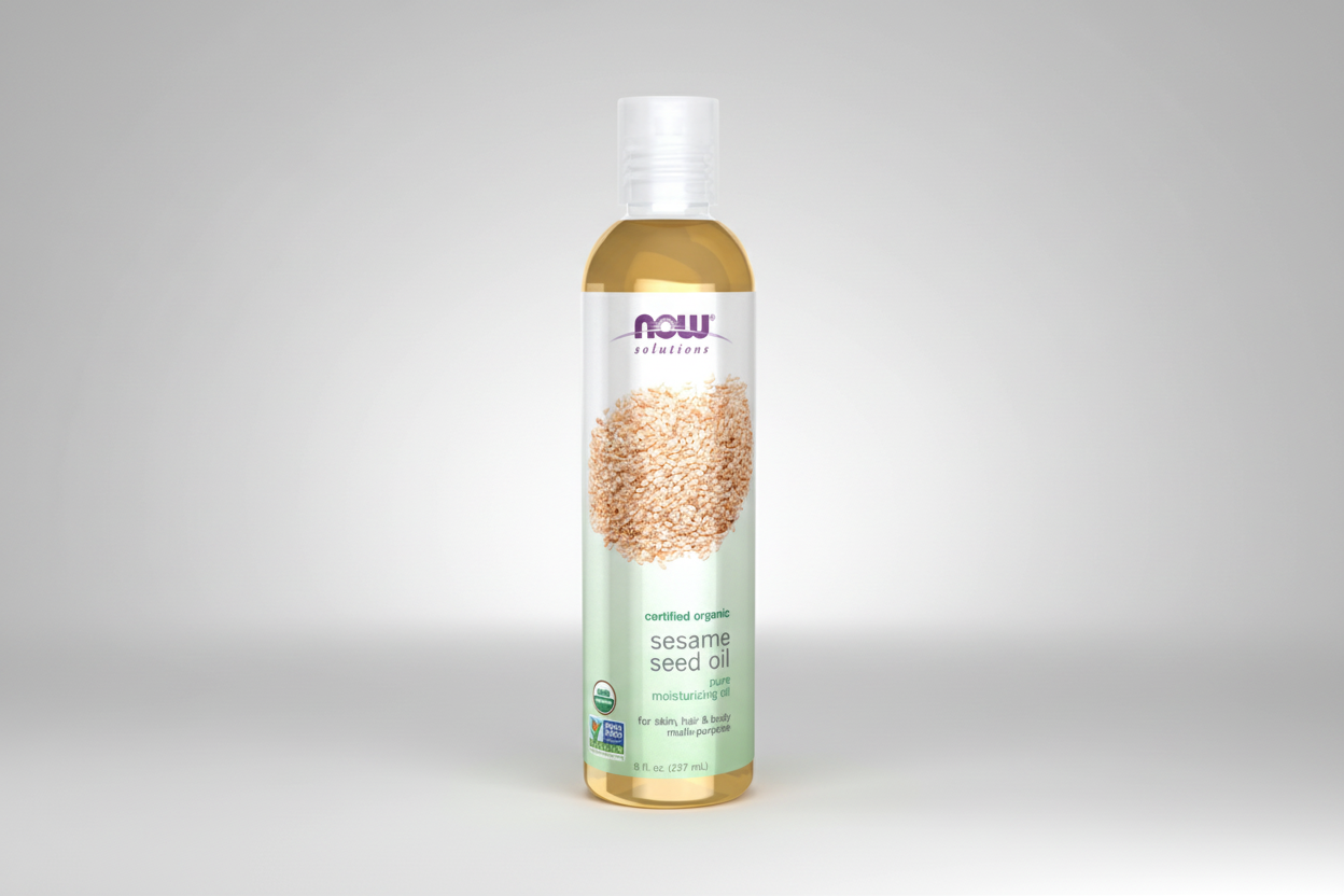 Bottle of NOW Solutions organic sesame seed oil on a white background