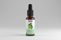 Bottle of NOW Solutions tamanu oil on a white background