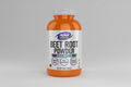Beet root powder supplement bottle with NOW Sports label on an orange background