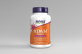 Supplement bottle labeled 'ADAM Capsules' with a purple cap and orange label.