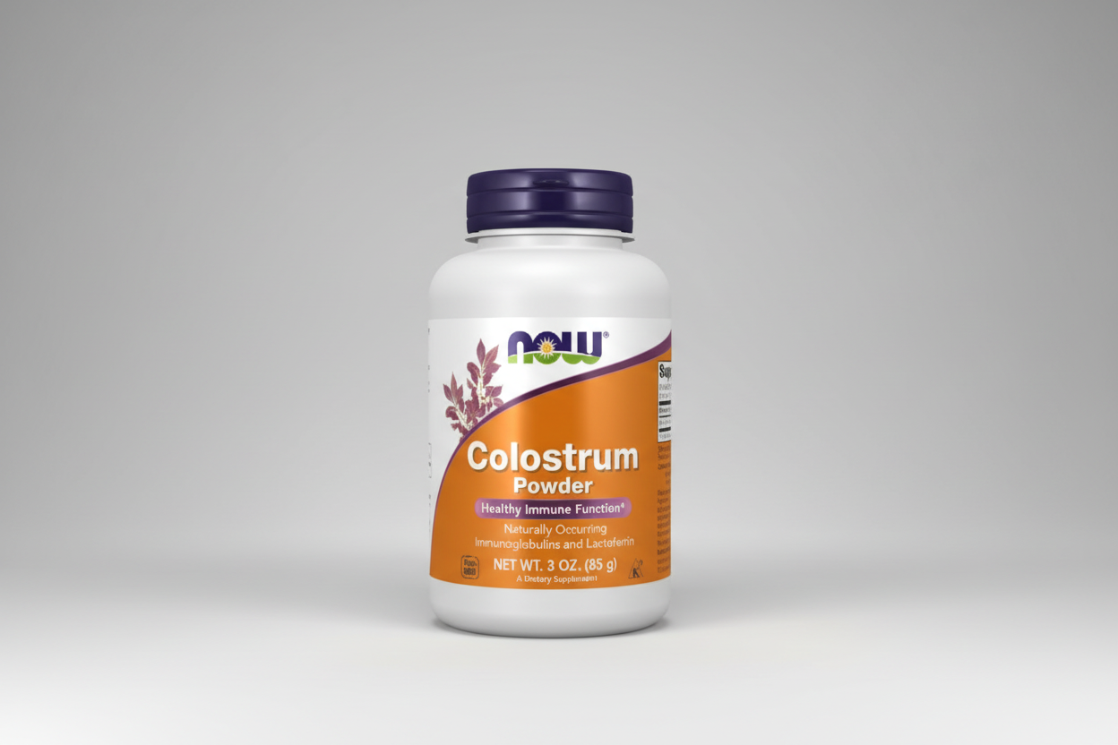 Colostrum powder supplement bottle with NOW brand on a white background