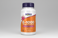 Supplement bottle labeled 'E-1000' with NOW brand on a white background