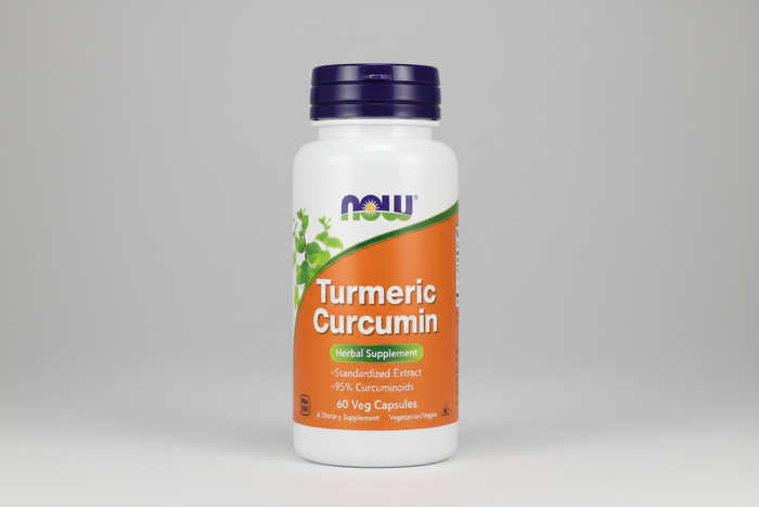 Supplement bottle labeled 'Turmeric Curcumin' with NOW brand on a white background
