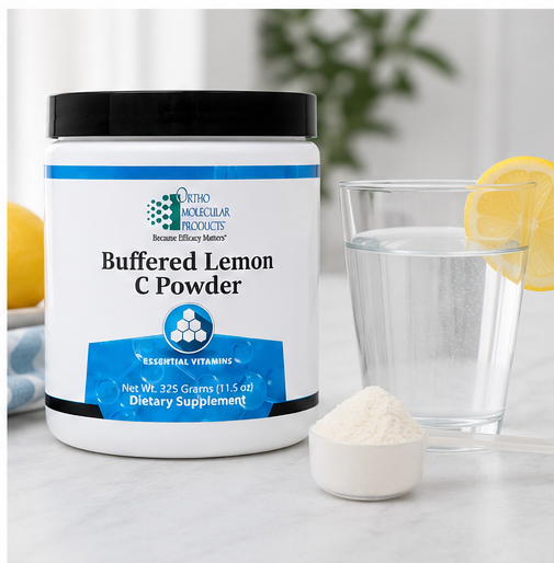 A white tub of Phytolabz Products Buffered Lemon C Powder dietary supplement with a black lid, shown next to a glass of water with a lemon slice and a small scoop of powder on a light marble surface.