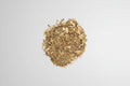 Heap of dried herbs on a white background