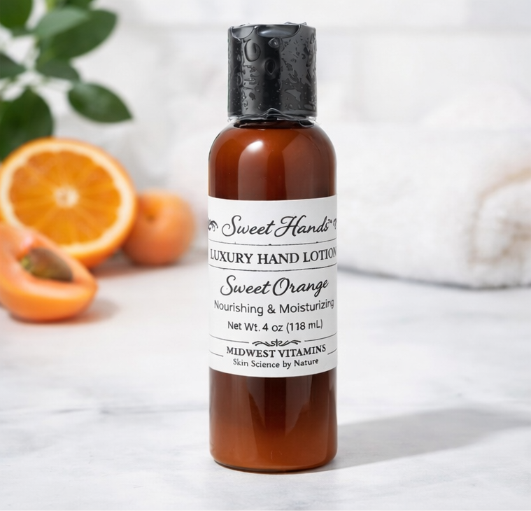 Bottle of Sweet Handz Luxury Hand Lotion with a label, surrounded by oranges on a light background