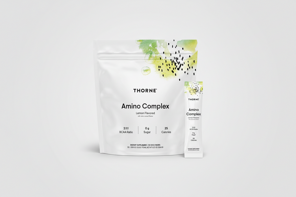 Thorne Amino Complex supplement package with lemon flavor on a black background