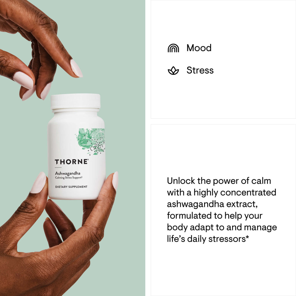 Thorne Ashwagandha supplement bottle held by a hand with a light green background