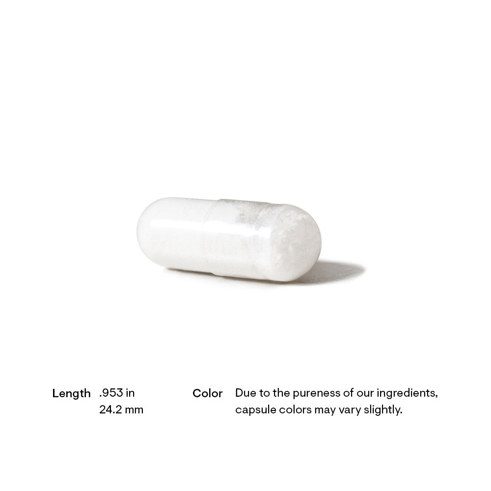 White capsule pill on a white background with text about dimensions and color variation.