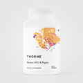 Thorne dietary supplement bottle with colorful label on a white background