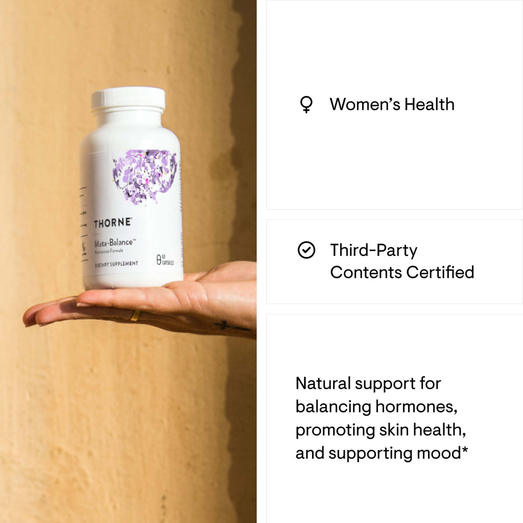 Thorne Women's Health supplement bottle held in a hand with product details on the right.